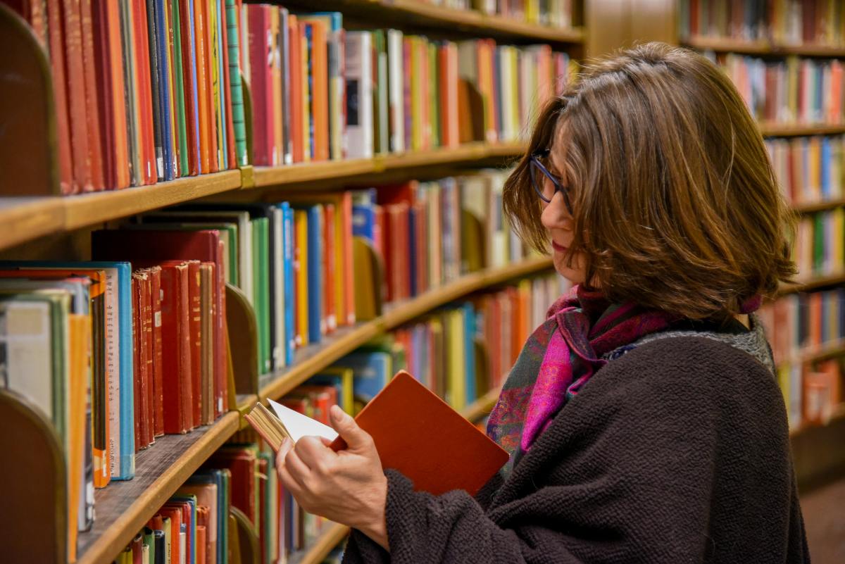 Woman reads a book in a library