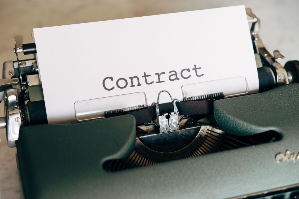 Typewriter with the word 'Contract' typed on a piece of paper